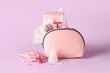 © Pixel-Shot - Cosmetic bag with different feminine hygiene items on pink background