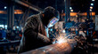 © MastersedZ - Welder welding metal factory spark protective helmet Industrial welder welding metal pipe factory workshop, bright spark