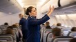© Being Imaginative - A smiling flight attendant in a blue uniform reaching up to stow a bag in an airplane overhead compartment.
