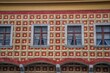 © Fabio - Colourful ornate building facade in Budapest with decorative red, yellow and green window frames.