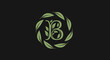 © Asri - Green letter B with leaf wreath on dark background
