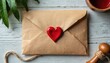 © Vadym - Brown kraft paper envelope with red heart wax seal sits on rustic wooden table. Twine and plants nearby suggest romantic correspondence or gift.