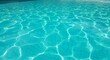 © Dragon - Aqua surface with shimmering sunlight reflections on tiled pool bottom