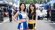 © AiPhoto - サーキットのピットウォークで並んで微笑む二人のレースクイーン