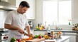 © SashaMagic - Man chopping vegetables in a modern kitchen