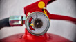 © Elif - Close-up of a fire extinguisher pressure gauge showing the needle in the green safe zone.