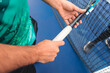 © Dani Nahuel/Stocksy - Hands Gripping a Tennis Racket on Court