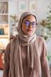 © Jovo Jovanovic/Stocksy - Portrait of a woman wearing a hijab and glasses.