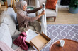 © Jovo Jovanovic/Stocksy - Woman in hijab unboxing new clothes at home.