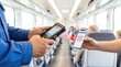 © Stitch - Train inspector hands using a digital scanner device to read a ticket QR code from a passenger smartphone screen