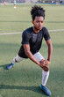 © Jovo Jovanovic/Stocksy - Young soccer player stretching during training