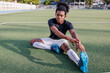 © Jovo Jovanovic/Stocksy - Young Black rugby player stretches on field