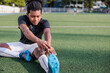 © Jovo Jovanovic/Stocksy - Soccer player stretches before practice