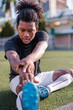 © Jovo Jovanovic/Stocksy - Young Black athlete stretching