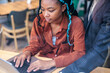 © Jovo Jovanovic/Stocksy - Woman with blue braids works on laptop with mentor.