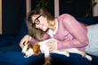 © Asya Molochkova/Stocksy - Woman Relaxing With Dog on Sofa at Home