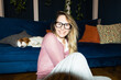 © Asya Molochkova/Stocksy - Smiling Woman with Glasses and Dog in Modern Apartment