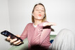 © Asya Molochkova/Stocksy - Stylish Woman Blowing Kiss in Headphones with Flash