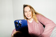 © Asya Molochkova/Stocksy - Smiling Blonde Woman with Phone Wide Angle Flash
