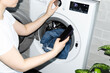 © Asya Molochkova/Stocksy - Unrecognizable Woman Selecting Wash Cycle With Phone