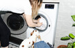 © Asya Molochkova/Stocksy - Woman with Dog Taking Towel from Dryer