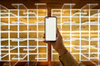 © Alvaro Lavin/Stocksy - Hand holding smartphone with blank screen in optical shop