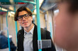 © Artcore Studio/Stocksy - Man talking on subway train