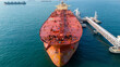 © Yellow Boat - Massive oil tanker ship at maritime loading terminal for global energy logistics and petroleum freight transport. International cargo supply chain, crude oil export