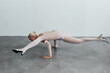 © Serge Filimonov/Stocksy - Woman balance on floor on hands