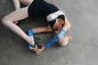 © Serge Filimonov/Stocksy - Overhead view of flexible woman pose on floor - Fashion