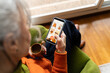 © Alba Studio/Stocksy - Senior woman shopping clothes online home