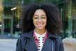 © Oleksii Syrotkin/Stocksy - Portrait of young smiling black successful woman looking at camera