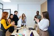 © Manu Padilla/Stocksy - Diverse team celebrating success applauding during office meeting