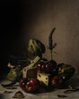 © Daniela Constantini/Stocksy - Still Life with Artichokes, Cheese, Tomatoes, Flowers, and Insects