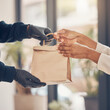 © A - Person handing over a food delivery bag through a window