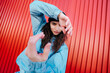 © Lucas Ottone/Stocksy - Confident young urban woman looking at camera portrait