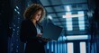 © PNG - Woman Working on Laptop in Modern Data Center Server Room.