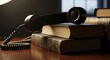 © Dika - Vintage Telephone Resting on Stack of Books in Dimly Lit Room.