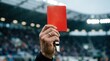 © Hypnyo - Soccer red card and penalty concept, referee hand holding red card in stadium. Rejection, failure and business warning for disciplinary violation.