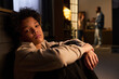 © pressmaster - Portrait of teenage boy sitting alone and looking at camera while parents arguing in background, expressing family stress and emotional conflict. Useful for parenting, divorce