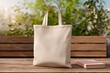 © Microstocke - Blank canvas tote bag mockup on wooden table outdoors