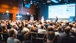 © Selvi - Business conference session with audience listening to presentation and large screen display in modern conference room