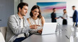 © Alexandr Peers - Software demo guiding a workflow rollout as two specialists compare options on screen and align next actions while partners in the background prepare documents for the final approval stage