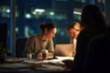 © Microstocke - Blurred Team working late in office at night, focused on laptop screen, modern workspace