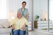 © New Africa - Portrait of smiling care worker with senior woman in wheelchair at nursing home. Space for text
