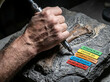 © Arif - Paleontology in action a close-up of a fossil being meticulously excavated and documented by a dedicated scientist