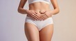 © xoss gallery - Woman holding her stomach in white underwear, female belly and torso close up, digestive health and body care concept