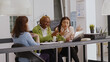 © DC Studio - Diverse team of coworkers doing collaboration in office to plan annual report, checking online analytics on files in coworking space. Female workers discussing corporate growth. Tripod shot.