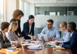 © stockart - Business meeting with diverse professionals collaborating around a table.