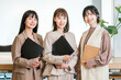 © buritora - Smiling businesswomen (working women, working mothers) lined up in an office.